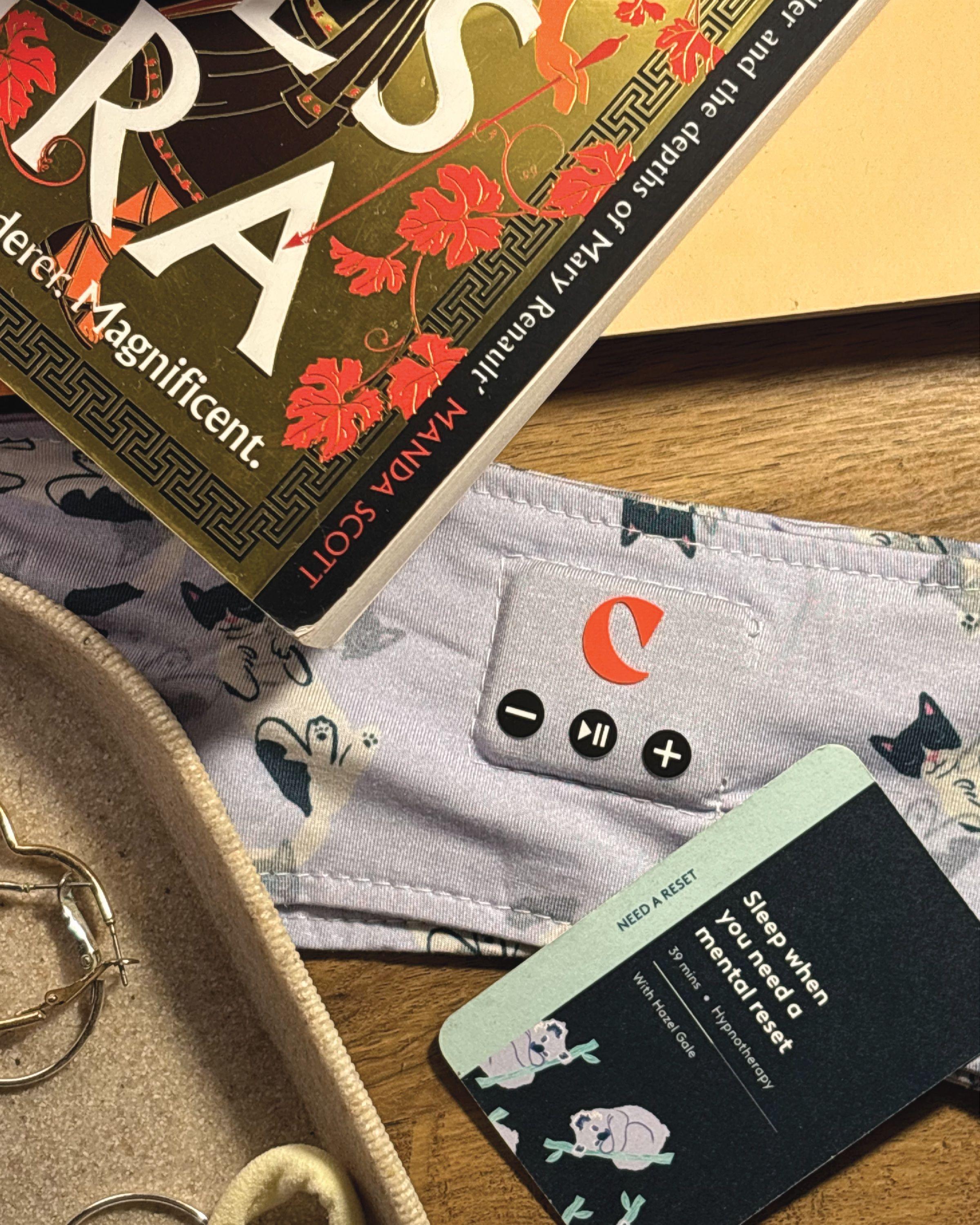 The Clementine headband and a session card on a bedside table beside a novel